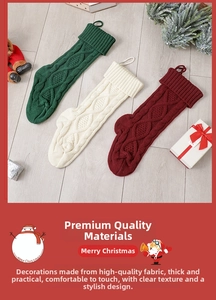 Close-up of knit Christmas stockings in green, white, and red on a wood background