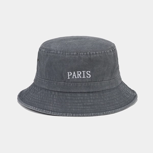 Close-up of vintage washed cotton bucket hat with white PARIS embroidery and metal eyelets
