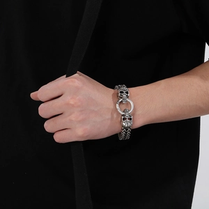 Close-up of punk style stainless steel skull bracelet worn on wrist for men and women