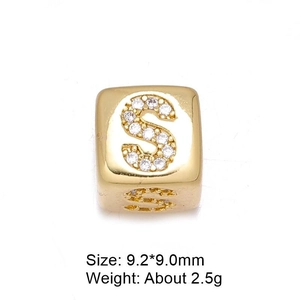 Detailed macro view of 8mm gold letter S cube bead with micro-paved cubic zirconia