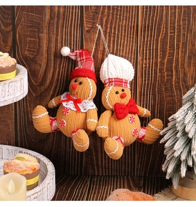 Close-up of gingerbread man plushies with corduroy texture on a festive wooden background