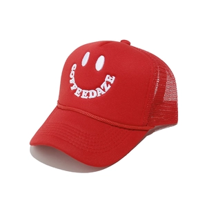 Detail of red trucker hat with white COFFEEDAZE embroidery and breathable mesh back