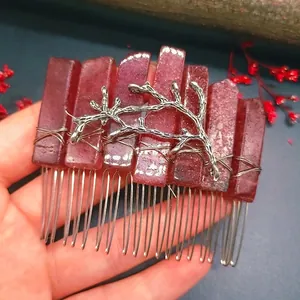 Detail of red crystal hair comb with silver branch branch and handcrafted wire wrapping