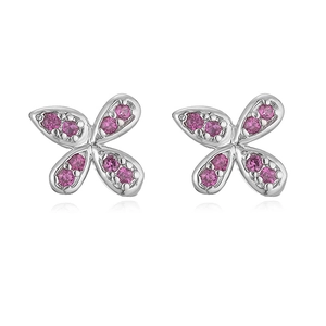 Macro detail of silver bow earrings with symmetrical pink crystals and polished finish