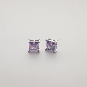 Close-up of square purple zircon stud earrings with silver four-prong setting