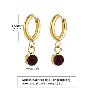 Detail view of gold stainless steel hoop earrings with 6mm red cubic zirconia charms