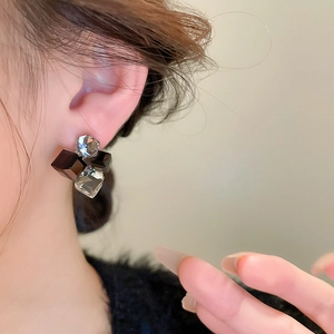 Vintage geometric cube stud earrings with black and clear crystals shown on a model