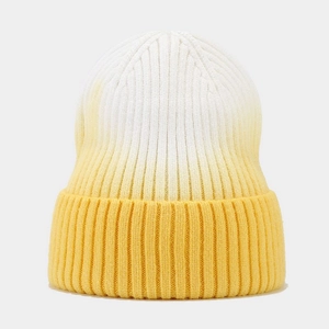 Detail of ribbed knit beanie featuring a white to yellow gradient color transition