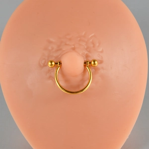 Detail of gold-plated G23 titanium nipple ring with opal and cubic zirconia inlay