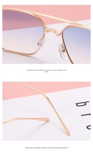 Detail of golden metal sunglasses with blue-pink gradient lenses and ergonomic nose pads