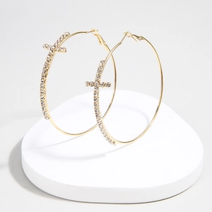 Elegant gold hoop earrings featuring sparkling rhinestones and a cross pendant detail