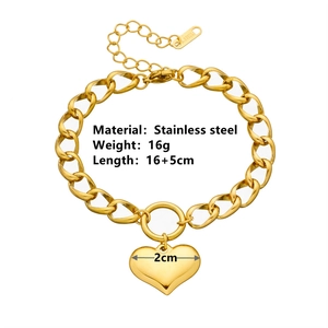 Detail of golden stainless steel heart charm with size specs and S.STEEL hallmark