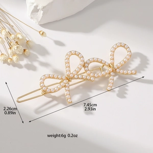 Elegant gold metal hair clip featuring three connected pearl-encrusted bows, 7.45cm long