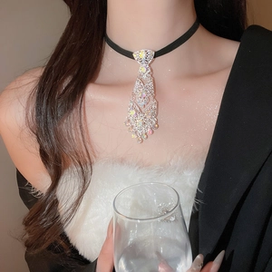 Detailed close-up of rhinestone tie choker with sparkling tassel pendant on model