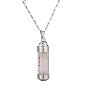Detailed shot of silver perfume bottle pendant with pink crystals and Greek fret pattern