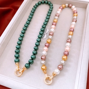 Macro shot of French vintage pearl necklaces with sparkling diamond-set circular clasps