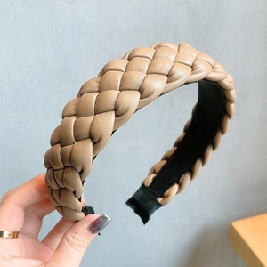 Detailed view of khaki braided PU leather headband featuring a thick woven texture