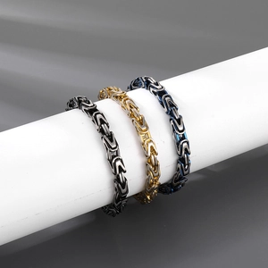 Detail of 8mm Byzantine chain bracelets in black, gold, and blue-black finishes