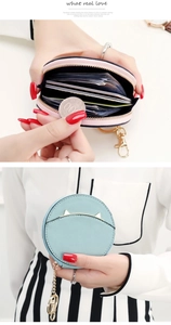 Detail of blue cat-ear coin purse showing pink interior lining and metal zipper