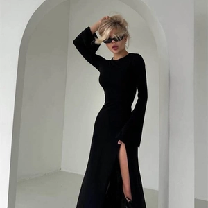 Elegant black long sleeve slim-fit dress with high slit and minimalist floor-length design