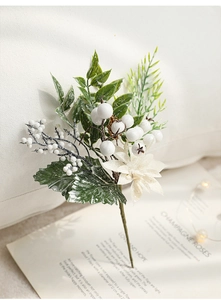 Detailed close-up of white festive berries and frosted flowers on a minimalist book background