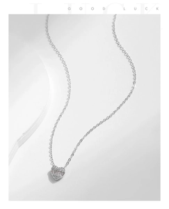 Detailed close-up of S925 silver heart pendant with baguette and round cubic zirconia stones