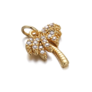 Detailed view of a gold palm tree pendant featuring sparkling zircon stone leaves