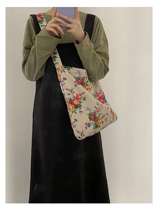 Floral canvas crossbody bag with vintage patterns shown on a female model