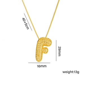 Detail view of gold letter F pendant with pave zircons showing size 29mm and weight 13g