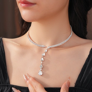 Detail shot of a silver Y-shaped drop necklace with zircon stones on a model