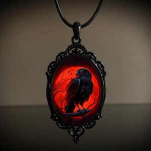 Gothic raven necklace with red moon pendant and intricate black metal cutout frame detail