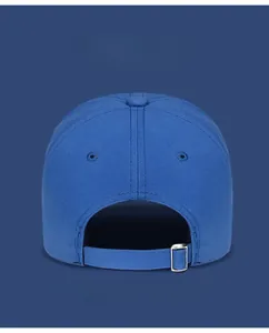 Detail of adjustable silver metal buckle on blue cotton golf cap back closure