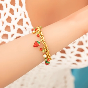 Gold stainless steel strawberry charm bracelet with red pendants and green bead accents