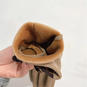 Close-up of khaki winter gloves showing the thick plush lining and suede-like texture