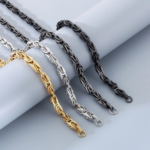 Close-up of Byzantine chains in gold, silver, black and grey steel for men's jewelry