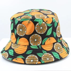 Detailed close-up of the bucket hat featuring vibrant orange citrus patterns on black fabric