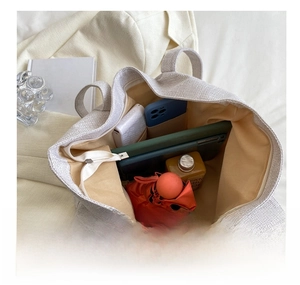 Interior view of large canvas tote bag showing high capacity storage for daily essentials