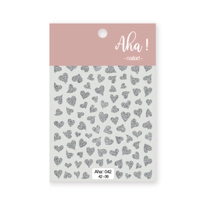 Macro detail of silver glitter heart nail art stickers with various sizes on a sheet