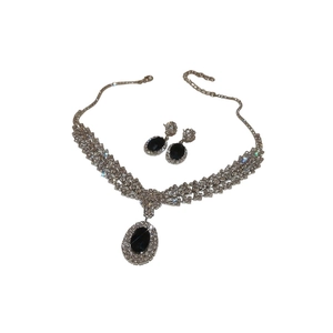 Elegant silver-toned jewelry set with oval black zircon pendant and matching earrings