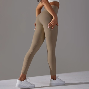 Detail of high-waisted khaki yoga leggings with seamless butt-lifting fabric texture