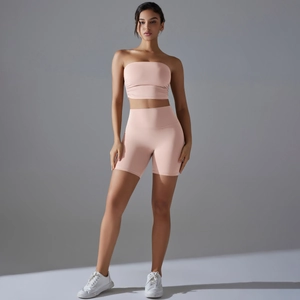Close-up of pink seamless yoga set featuring a tube top and high-waist biker shorts