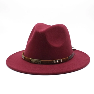 Detailed shot of burgundy wide-brim fedora hat with brown band and metal buckle
