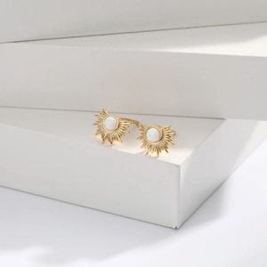 S925 silver sunburst stud earrings with opal stone on minimalist geometric display