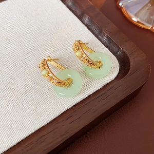 Détail de boucles d'oreilles papillon plaquées or 18 carats avec anneau en jade vert clair