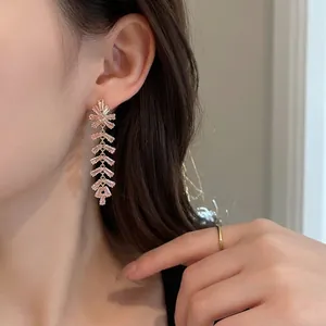 Elegant long tassel earrings with pink cubic zirconia crystals in gold-plated settings