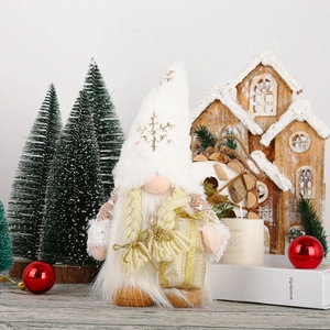 Detail of white snowflake hat Christmas gonk with golden braids and gift box decor