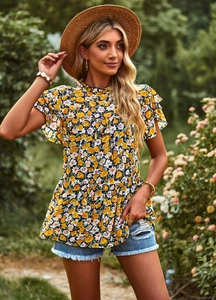 Floral print summer top with ruffled sleeves styled with denim shorts in a garden setting