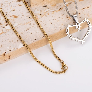 Hip hop punk heart pendant necklace set with gold box chain on beige travertine stone