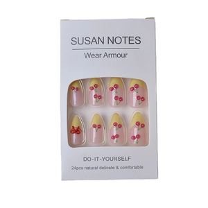 French blush press-on nails with 3D cherry and red bow accents on 24-piece set