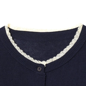 Navy blue knit cardigan featuring elegant cream lace trim on the collar and button detail